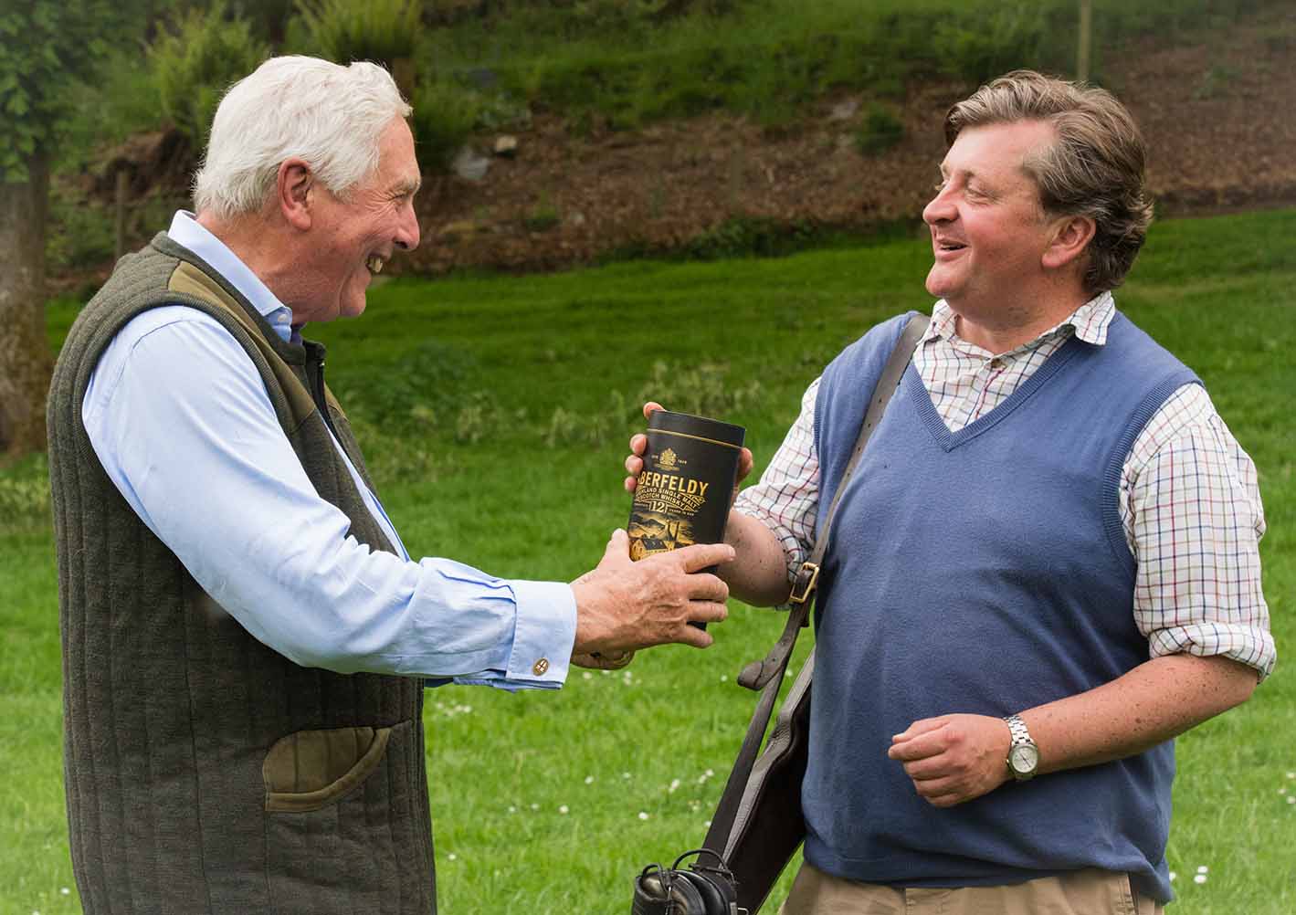 An image of Michael Campbell presenting Patrick Stuart-Fotheringham with a bottle of Aberfeldy as winner of the Charity Pool Shoot at Edradyante clay pigeon shoot day May 2017 - Edradynate Estate, Perthshire - Luxury Country House and Sporting Estate for Rent in Scotland